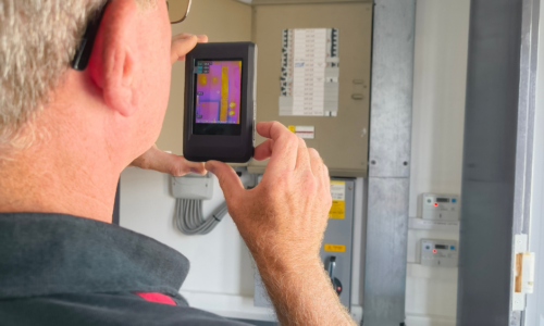 Thermal Imaging Commercial Electrician using thermal imaging camera on commercial wiring.